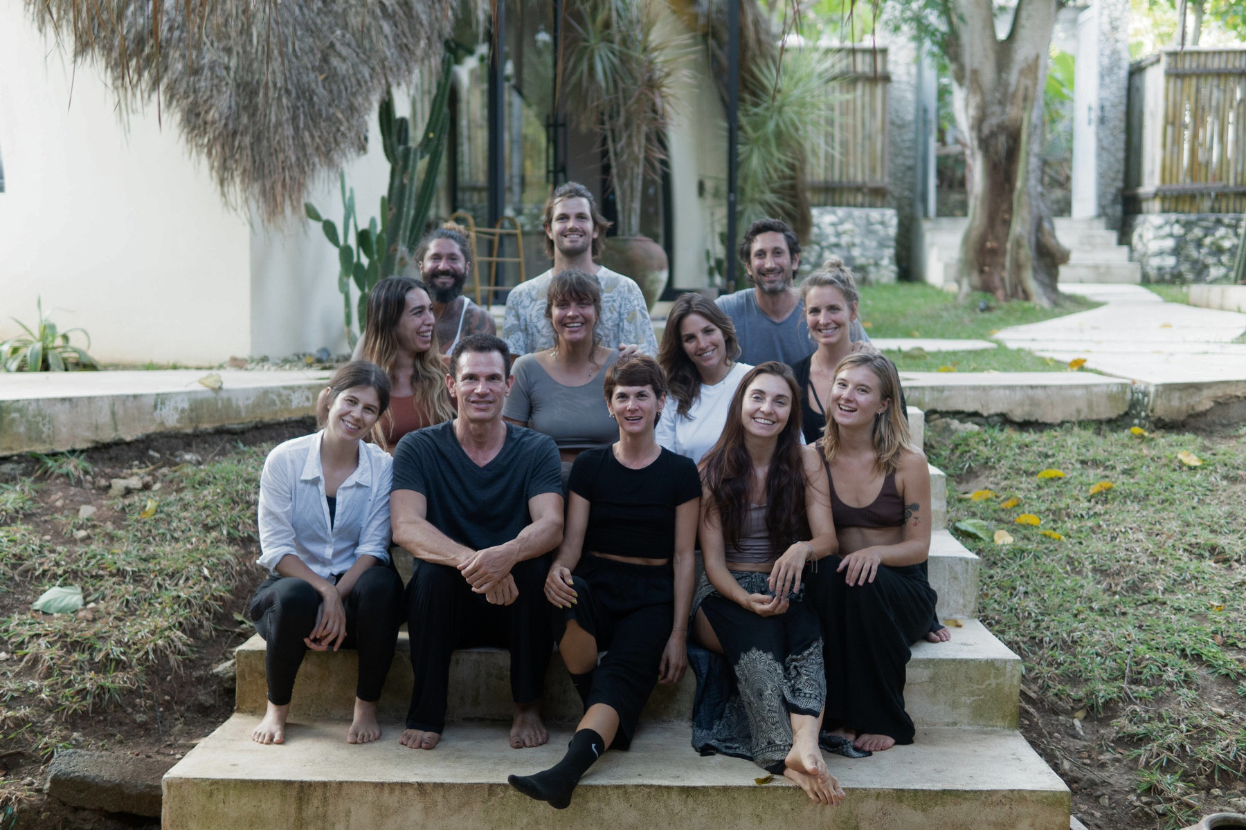 A Momentum training group smiling together on garden steps