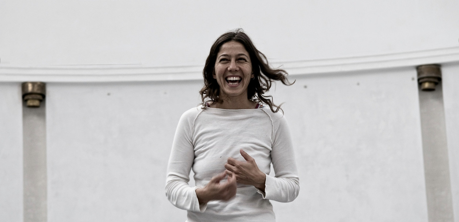 Leilani Weis laughing in a bright white room
