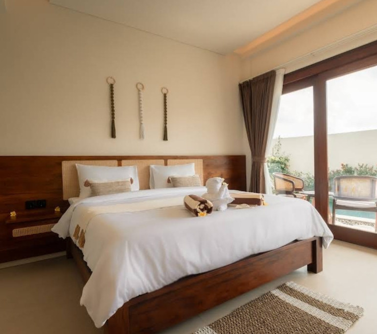 Another angle of a Rasa Yoga guest room with a sliding rattan wardrobe