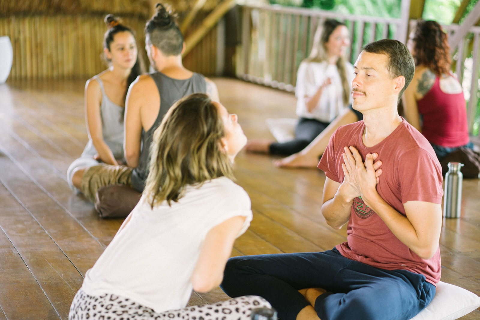 A dancer sharing with the group, hands at heart